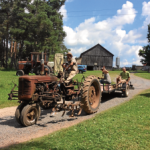 A beautiful day on the Farm at Backbone Food Farm in Plesant Valley as the kids at Farm Camp with All Earth Eco Tours watch the farmers go out to do chores on a vintage tractor.